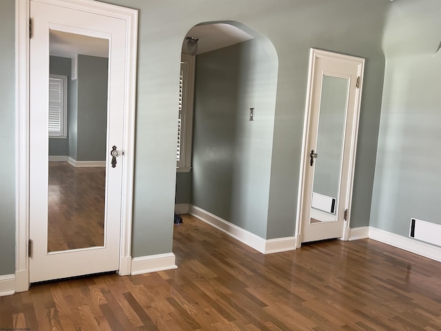 corridor with dark hardwood / wood-style flooring