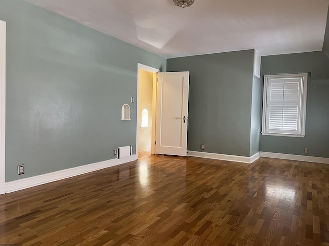 empty room featuring dark hardwood / wood-style flooring