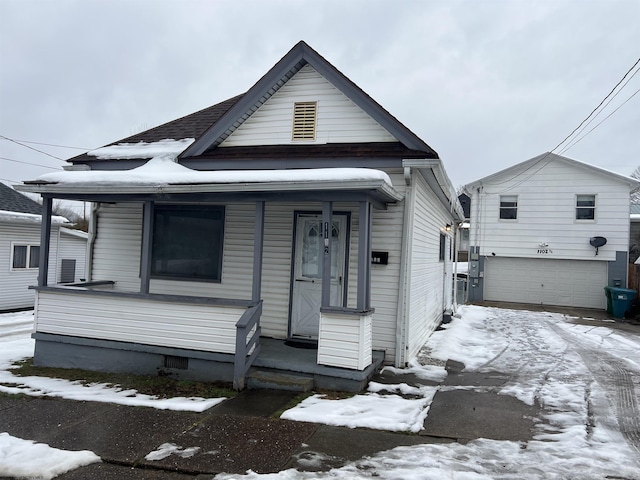 bungalow-style home with a garage and a porch