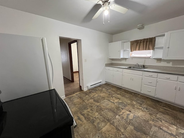 kitchen featuring white fridge, white cabinetry, ceiling fan, a baseboard radiator, and sink