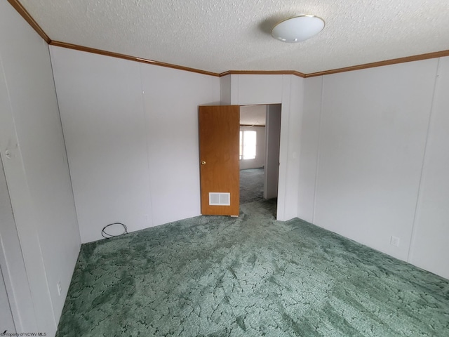 spare room with carpet floors and a textured ceiling