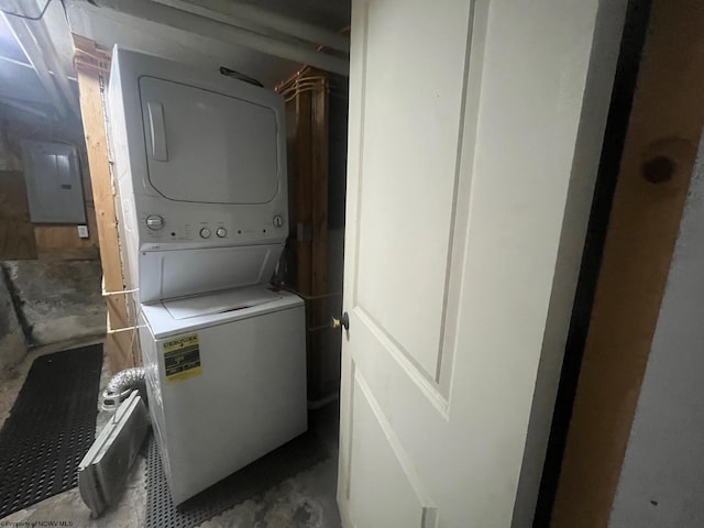 clothes washing area featuring stacked washing maching and dryer and electric panel