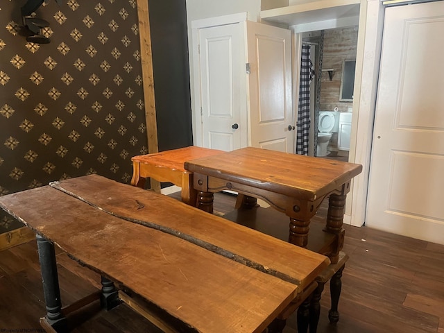 dining space with dark hardwood / wood-style flooring