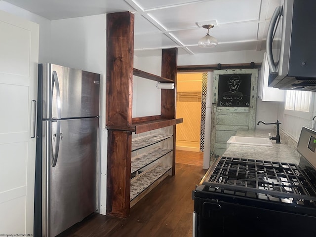 kitchen featuring sink, appliances with stainless steel finishes, and dark hardwood / wood-style floors