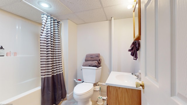 full bathroom with toilet, vanity, a paneled ceiling, and shower / bathtub combination with curtain