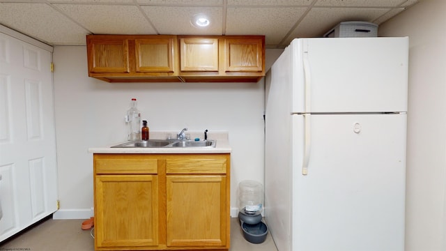 kitchen featuring sink, a paneled ceiling, and white fridge