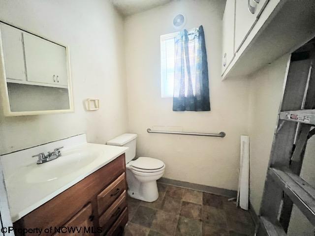 bathroom featuring toilet and vanity