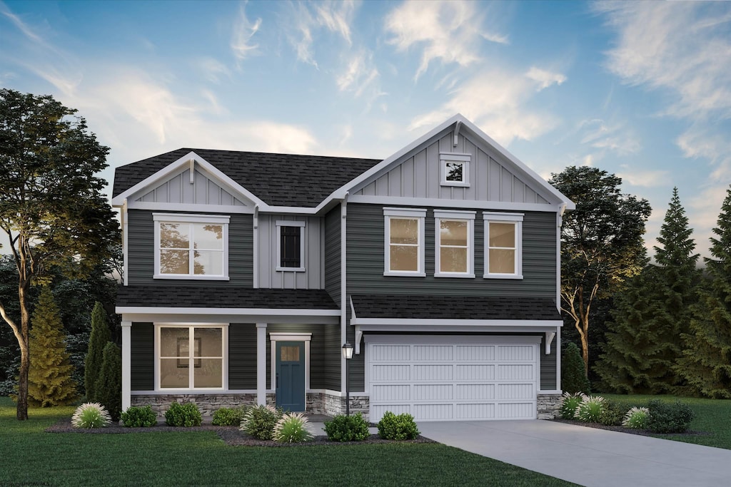 view of front of home featuring a front lawn and a garage