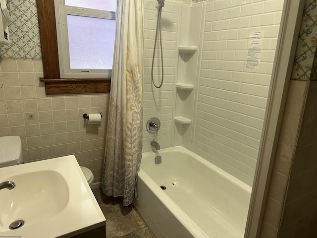 full bathroom featuring toilet, tile patterned flooring, tile walls, shower / bathtub combination with curtain, and vanity