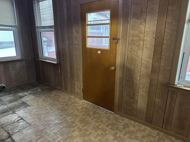 entryway with a healthy amount of sunlight and wooden walls