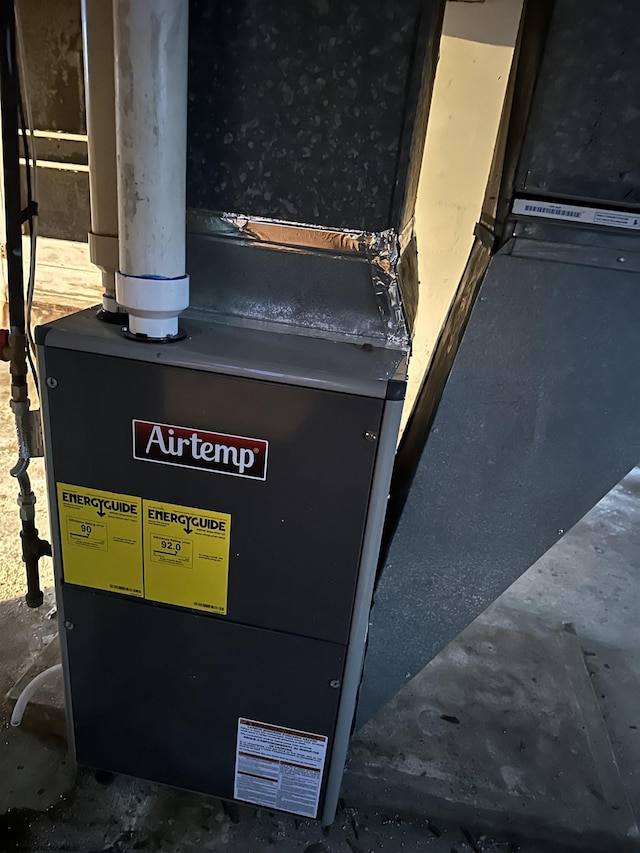 utility room featuring heating unit