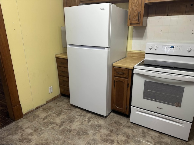 kitchen featuring decorative backsplash and white appliances