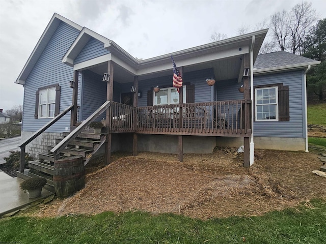 rear view of property featuring a porch