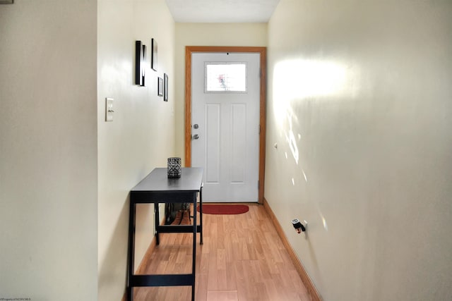 doorway with light wood-type flooring