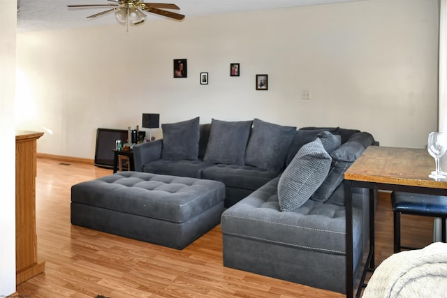 living room featuring ceiling fan and light wood-type flooring