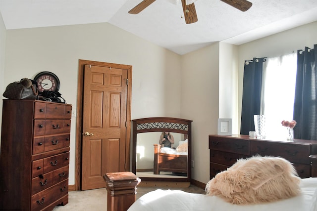 bedroom with ceiling fan, lofted ceiling, and light carpet