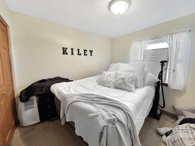 carpeted bedroom featuring a textured ceiling