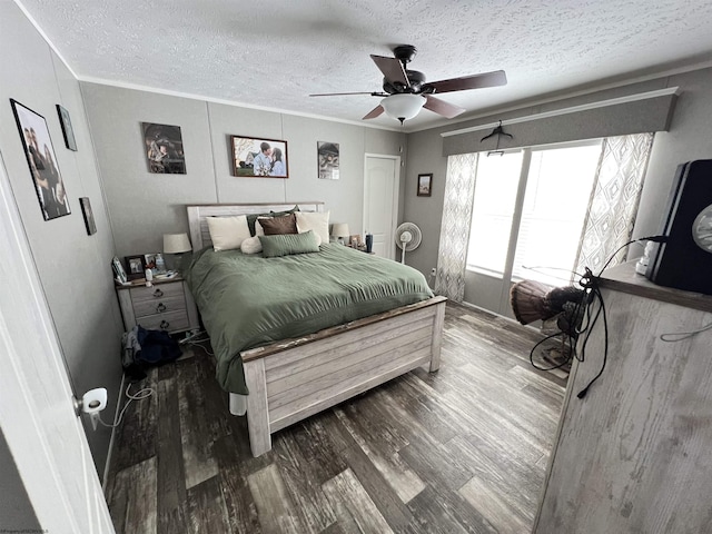 bedroom featuring ornamental molding, ceiling fan, a textured ceiling, and wood finished floors