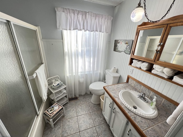 bathroom with tile patterned floors, vanity, and toilet