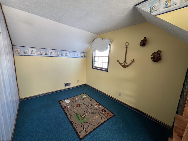 bonus room with carpet floors, a textured ceiling, and vaulted ceiling