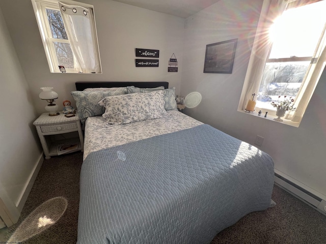 bedroom with a baseboard radiator and dark carpet