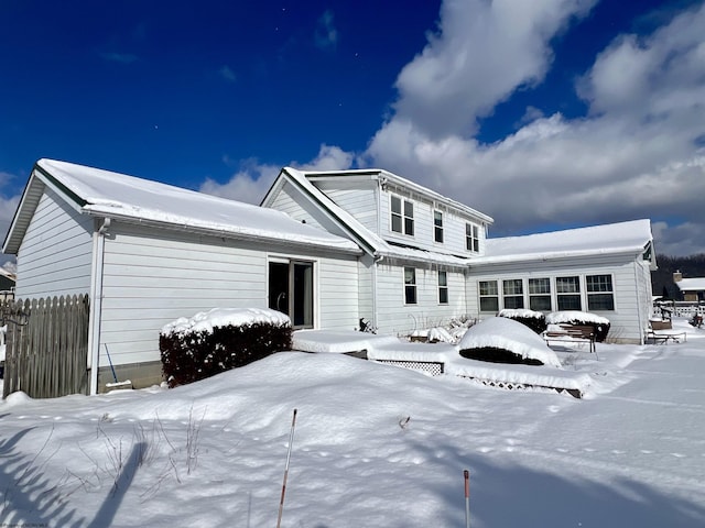 view of snow covered rear of property