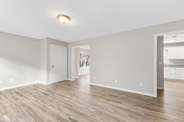 spare room featuring light hardwood / wood-style floors