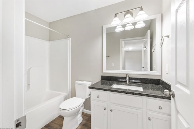 full bathroom featuring vanity, toilet, tub / shower combination, and hardwood / wood-style floors