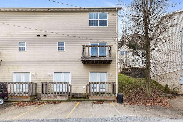 back of property featuring a balcony