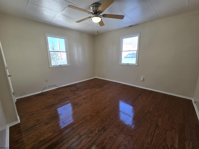 unfurnished room with ceiling fan and dark hardwood / wood-style floors