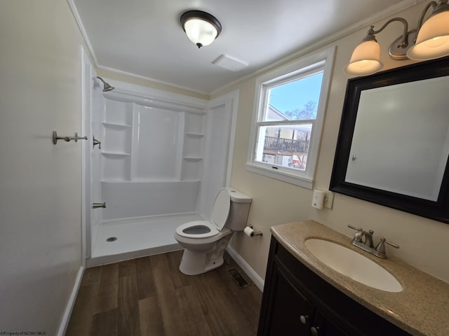 bathroom featuring a shower, wood-type flooring, toilet, and vanity