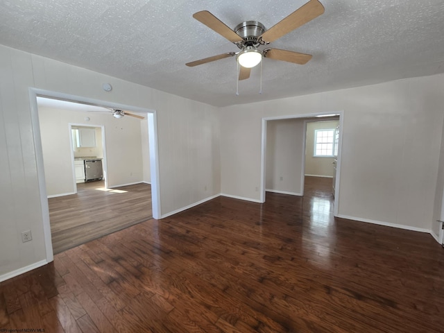 empty room with dark wood-type flooring, a textured ceiling, and ceiling fan