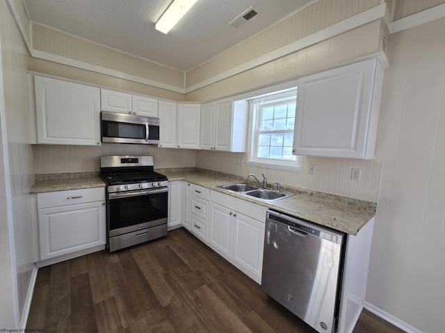 kitchen featuring sink, white cabinetry, dark hardwood / wood-style floors, and appliances with stainless steel finishes