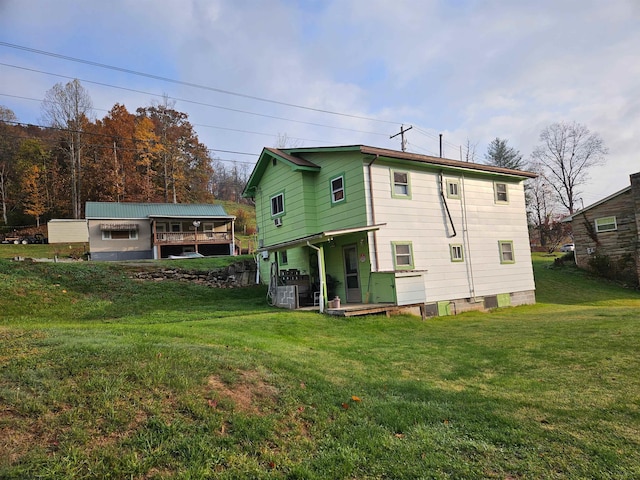 rear view of property with a yard