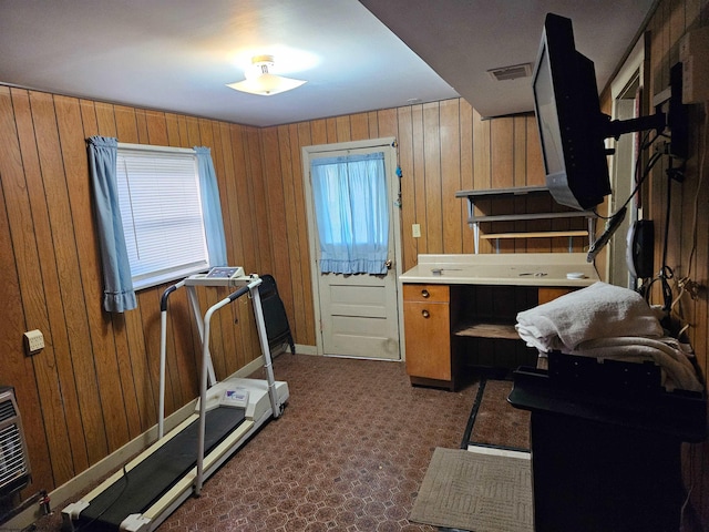 exercise room featuring wooden walls