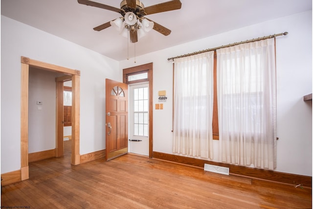 entrance foyer featuring hardwood / wood-style flooring, a wealth of natural light, and ceiling fan