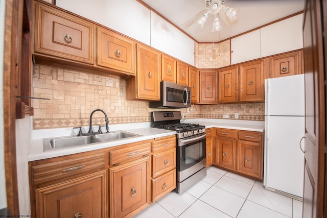 kitchen with sink, tasteful backsplash, light tile patterned floors, ceiling fan, and stainless steel appliances