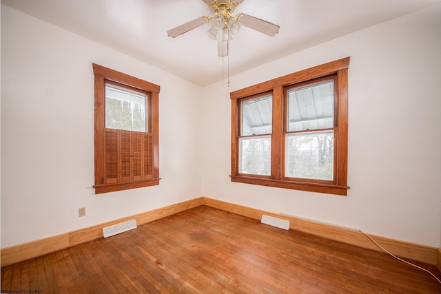 spare room featuring hardwood / wood-style floors and ceiling fan