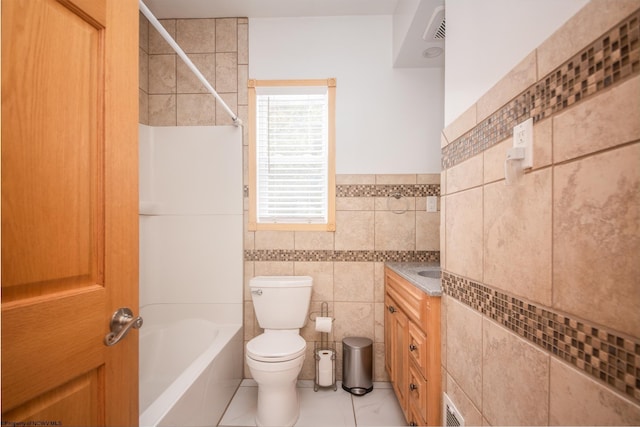 full bathroom featuring  shower combination, tile patterned flooring, tile walls, vanity, and toilet