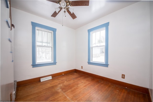 spare room featuring hardwood / wood-style flooring and ceiling fan