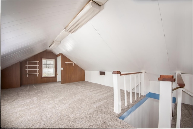 additional living space with vaulted ceiling and carpet