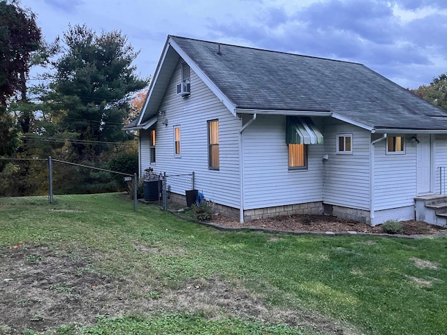 view of property exterior featuring central AC and a lawn