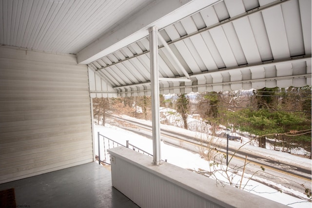 unfurnished sunroom featuring vaulted ceiling