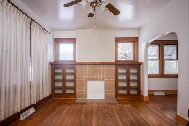 unfurnished living room with wood-type flooring and a fireplace