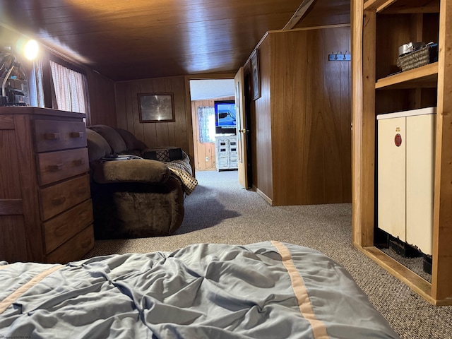 carpeted bedroom featuring wooden ceiling and wood walls