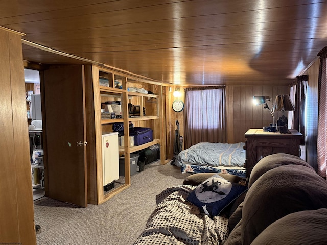 carpeted bedroom with wooden ceiling and wood walls