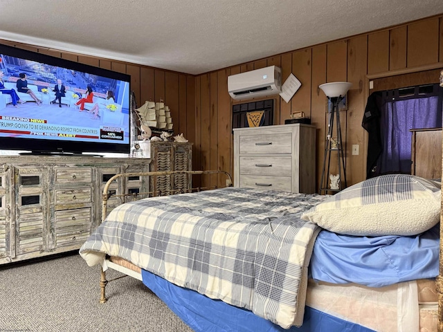 carpeted bedroom with a wall mounted air conditioner, wooden walls, and a textured ceiling