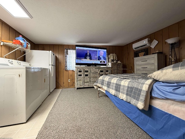 bedroom with washing machine and clothes dryer, a wall mounted air conditioner, a textured ceiling, wooden walls, and white fridge