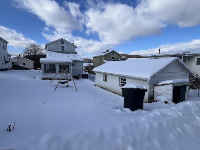 view of snow covered back of property