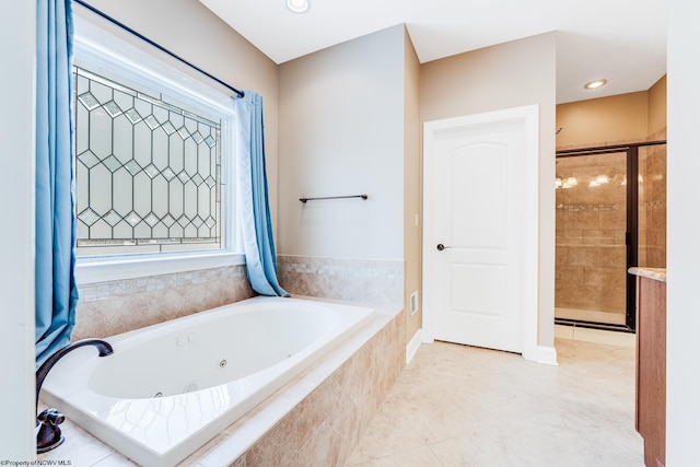 bathroom with tile patterned floors and independent shower and bath